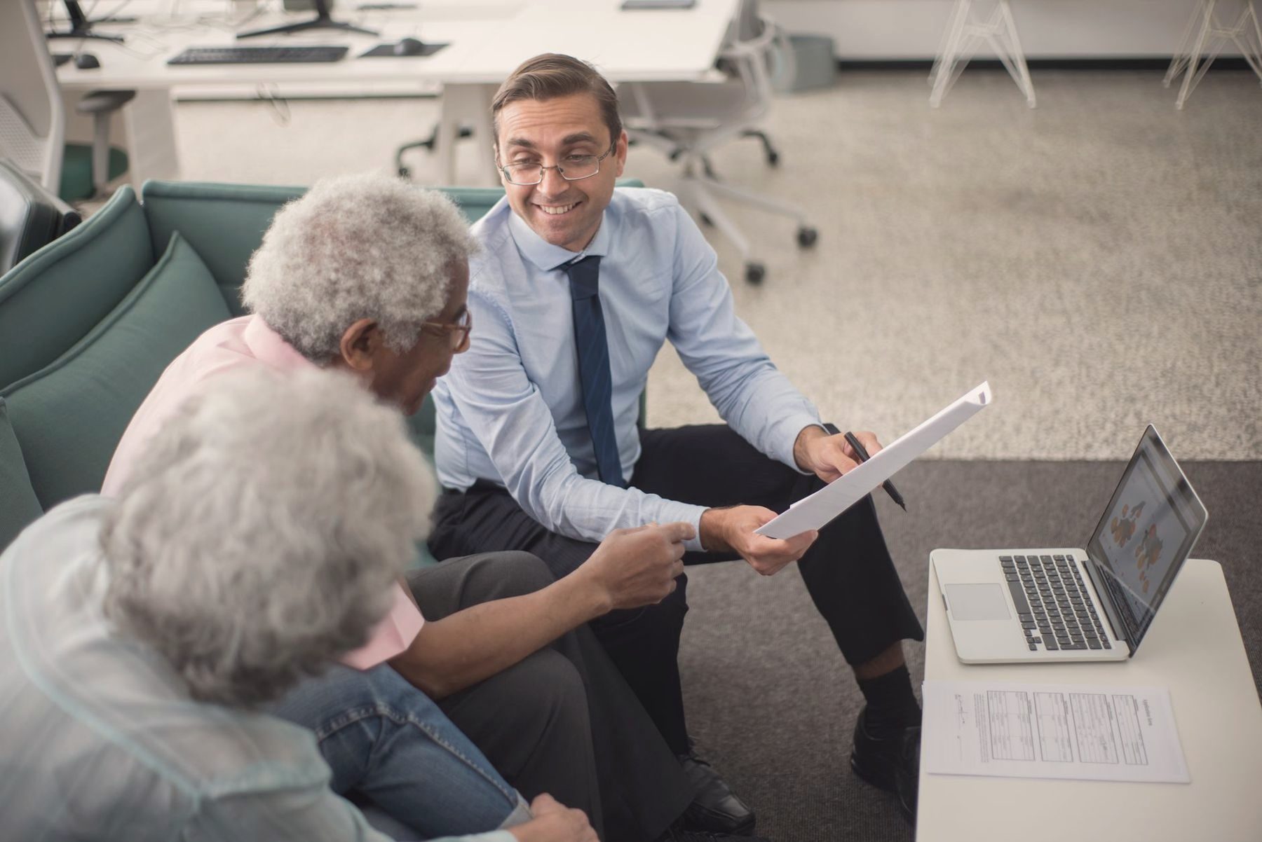 An advisor reviewing documents with an older couple at home